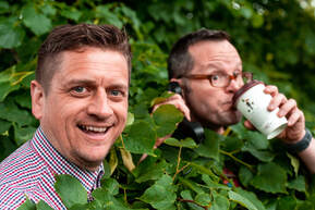 Alan Donegan and Simon Paine in a bush drinking coffee.  Rebel Business School